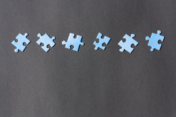 Puzzle pieces on a dark background.