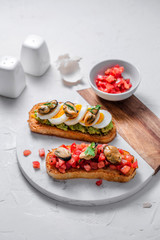 Mussels with tomato and eggs on grilled toasts