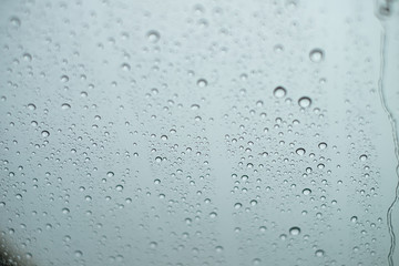 Close up Drops of water on the glass in the rainy season