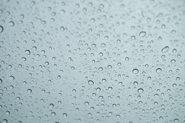 Close up Drops of water on the glass in the rainy season