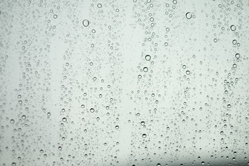Close up Drops of water on the glass in the rainy season
