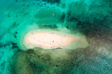 Naked Island, Siargao. The white sandy island is surrounded by a coral reef, a top view. Philippine nature.