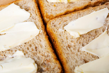Sliced toast bread with butter background.