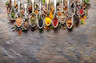 Herbs and spices on black stone