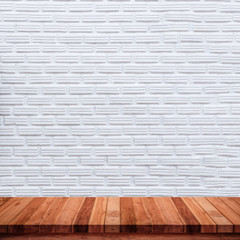 Empty wood table with white brick wall background.