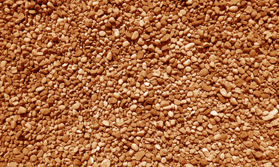 Pile of small gravel stones in orange tone.