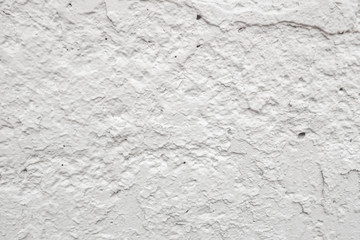 abstract background of a shabby old wall painted in white close up