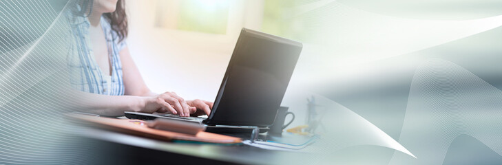 Fototapeta premium Young attractive businesswoman working on laptop, light effect; panoramic banner