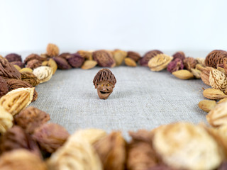 The male face figurine, piece of food art, fruit pit carving, good luck wish symbol, in the center...