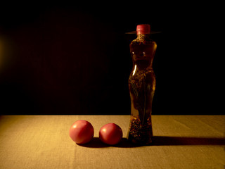 Transparent plastic bottle in the shape of a woman with a hat, with various spices and olive oil...