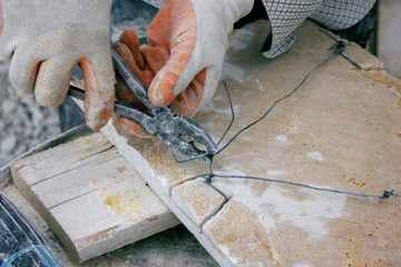 man works with a stone