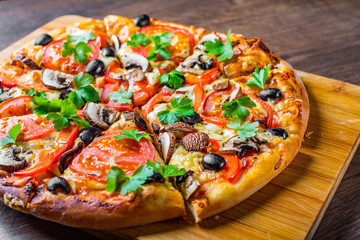 sliced Pizza with Mozzarella cheese, Tomatoes, pepper, olive, mushrooms, Spices and Fresh leaf....
