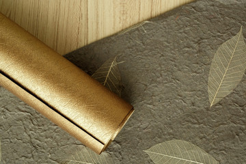 Paper gold sheet and Handmade brown Mulberry paper on wooden floor for Merry christmas and Happy new year