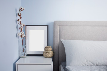 Black flame poster mockup in cozy scandinavian bedroom with blue walls. Scandinavian bedroom interior