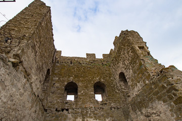 Ancient fortress on a mountain with green southern grass