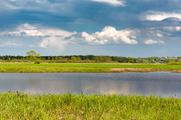 landscape with river and blue sky.
