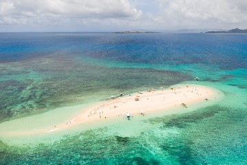 Naked Island, Siargao. The white sandy island is surrounded by a coral reef, a top view. Philippine nature.
