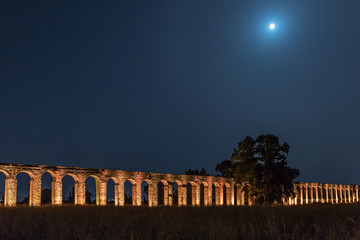 Fototapeta premium Night view of the remains of an ancient Roman aqueduct located between Acre and Nahariya in Israel