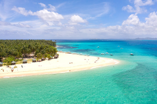 Seascape with a beautiful island. Daco island, Philippines. Tropical island with a white sandy beach for tourists. Island to relax.