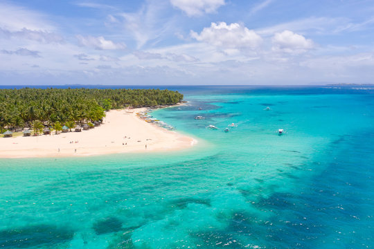 Seascape with a beautiful island. Daco island, Philippines. Tropical island with a white sandy beach for tourists. Island to relax.