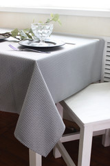plates are on the table, a table with a gray tablecloth, a served table