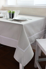 plates are on the table, a table with a gray tablecloth, a served table