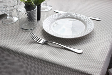 plates are on the table, a table with a gray tablecloth, a served table