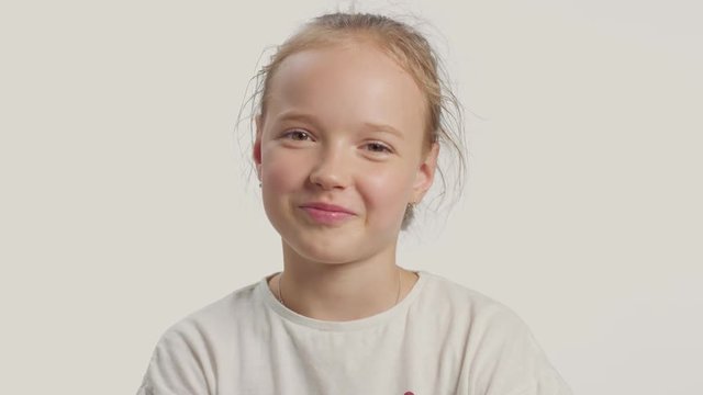 young girl makes facepalm and laughing then