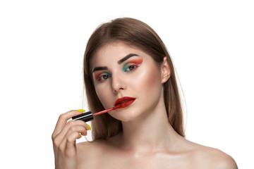 Closeup portrait of beautiful young woman with brushes for make-up