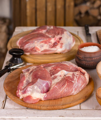 Two large meat fillets on wooden boards, near salt. Step by step recipe. Photo series