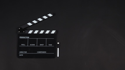 Fototapeta na wymiar Clapperboard or clap board or movie slate with pen use in video production ,film, cinema industry on black background.