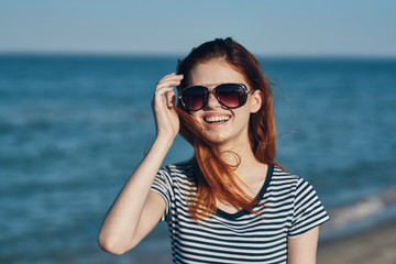 young woman with sunglasses on the beach