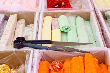 Traditional sweets and scissors on the Turkish bazaar, selective fokus.