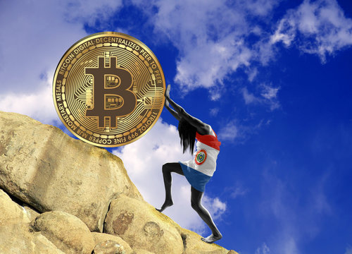 A girl wrapped in a Paraguay flag raises a bitcoin coin up the hill.
