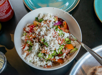 Mixed vegetables salad with grated salted cheese