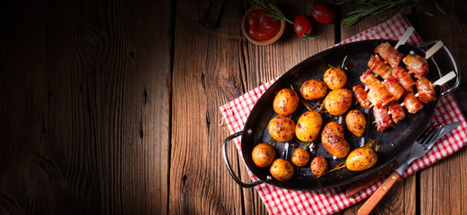 Rustic dates wrapped in bacon and young roasted potato.