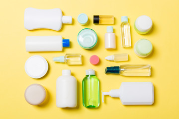 Group of plastic bodycare bottle Flat lay composition with cosmetic products on yellow background empty space for you design. Set of White Cosmetic containers, top view with copy space