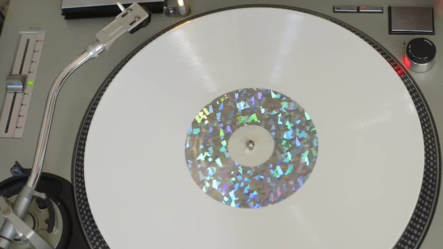 A fan of high-fidelity music changes the headshell by unscrewing it from the arm for listening to a vinyl