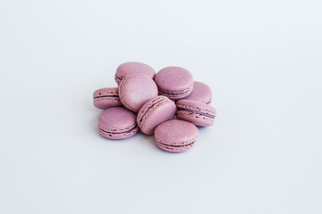 Delicious almond macaroons with filling on a white background