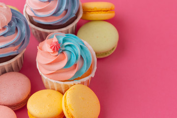 Tasty cupcakes sweets on pink background close up