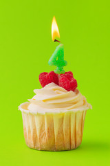 Delicious cupcakes with candles on a colored background. Festive background, birthday