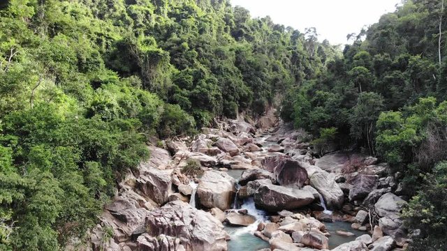 Small Mountain River with Large Stones Among the Tropical Forest in Vietnam