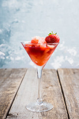 Frozen strawberry cocktail in martini glass. Selective focus.