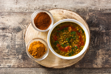 Indian lentil soup dal (dhal) in a bowl on wooden table. Top view