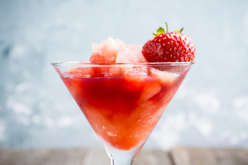 Frozen strawberry cocktail in martini glass. Selective focus.