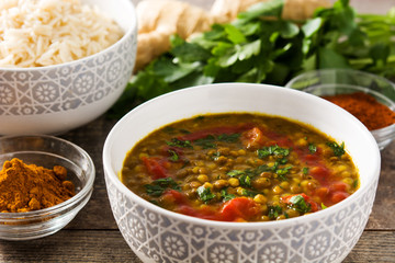 Indian lentil soup dal (dhal) in a bowl on wooden table