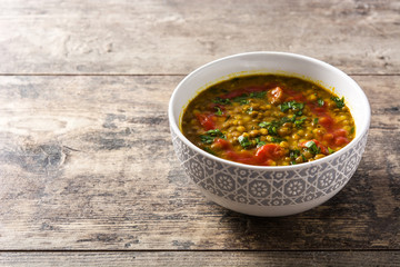 Indian lentil soup dal (dhal) in a bowl on wooden table. Copyspace