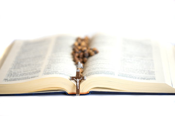 Fototapeta premium Open Holy Bible in the light with the Cross. Faith, spirtuality and Christianity religion concept.