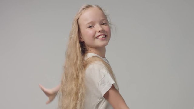 young girl moves like bird in studio alone with hair blowing