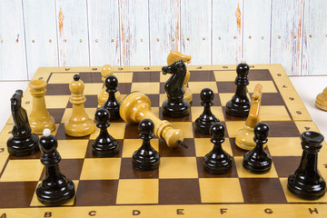 Concept of chess game with realistic Board and black-and-white figures against the light boards....
